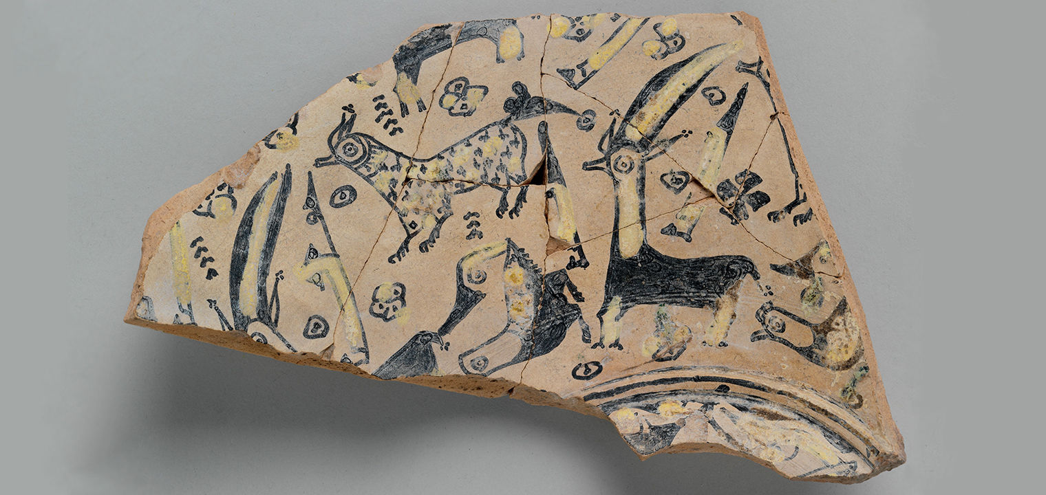 a buffware fragment with animal decoration including birds and horned and spotted quadrupeds
