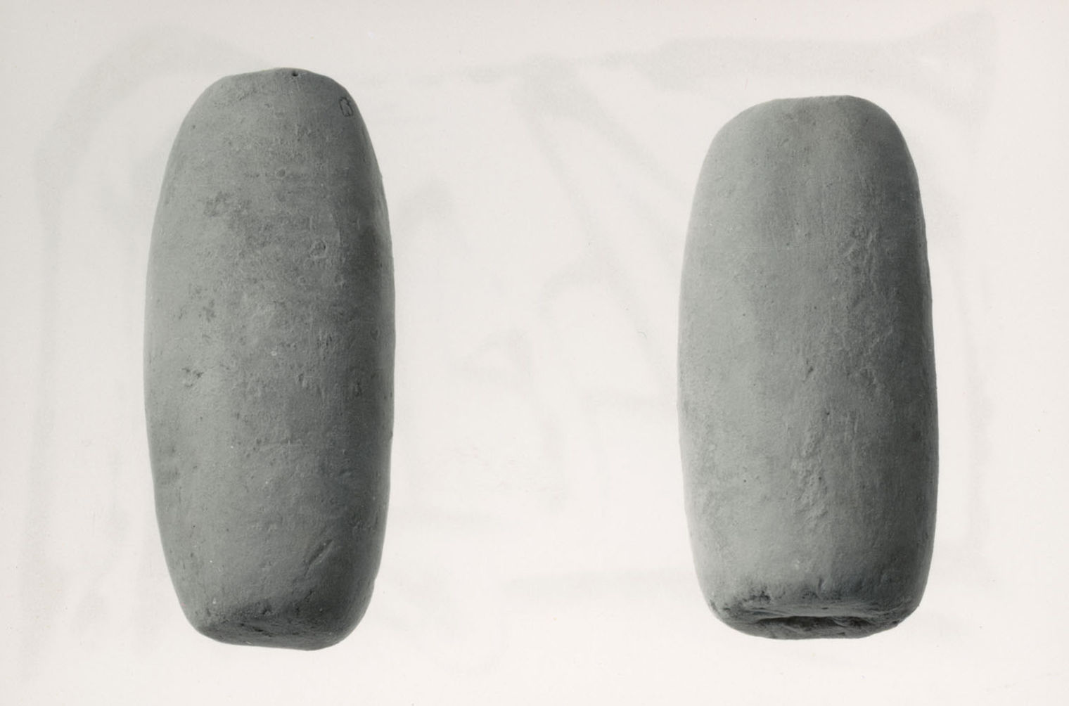 a black and white photo of two cylinders of Nishapur's edible earth
