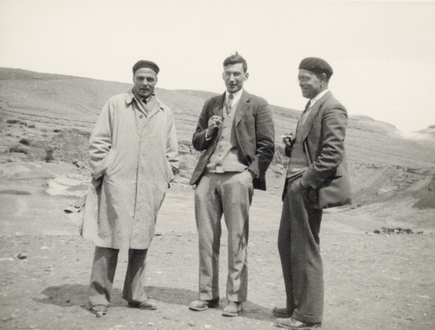 Black and white image of Joseph Upton, Walter Hauser, and Charles Wilkinson standing in a row in Nishapur 
