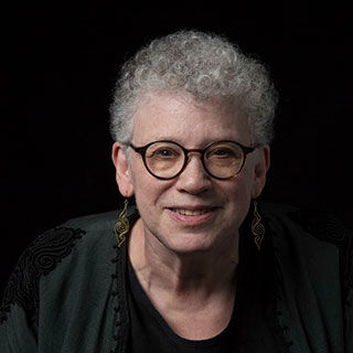 Woman with gray hair wearing glasses 