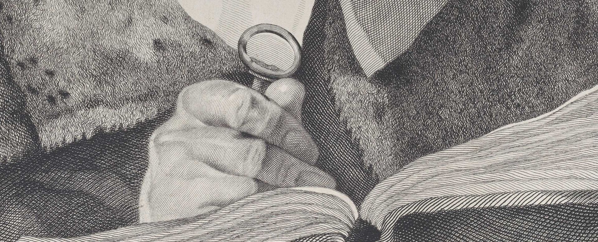 Detail of a print of a man's hand holding a magnifying glass to a book