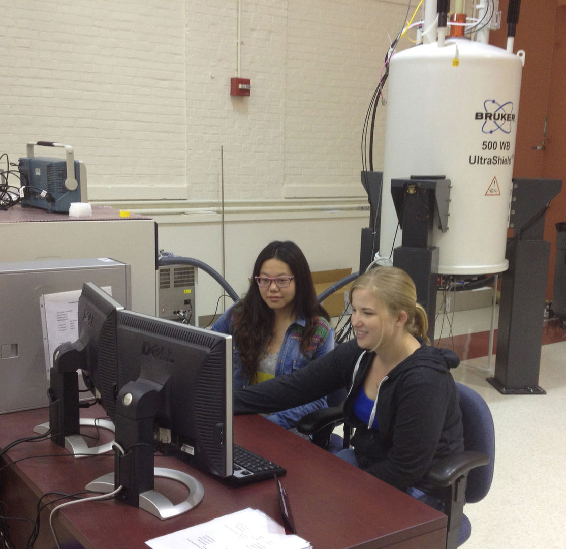 University of Delaware students Anna Murphy and Yao Yao using the solid-state NMR spectrometer.