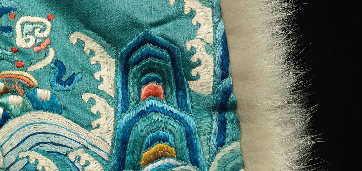 Detail from a bright blue Qing Dynasty ceremonial robe with a fur trim