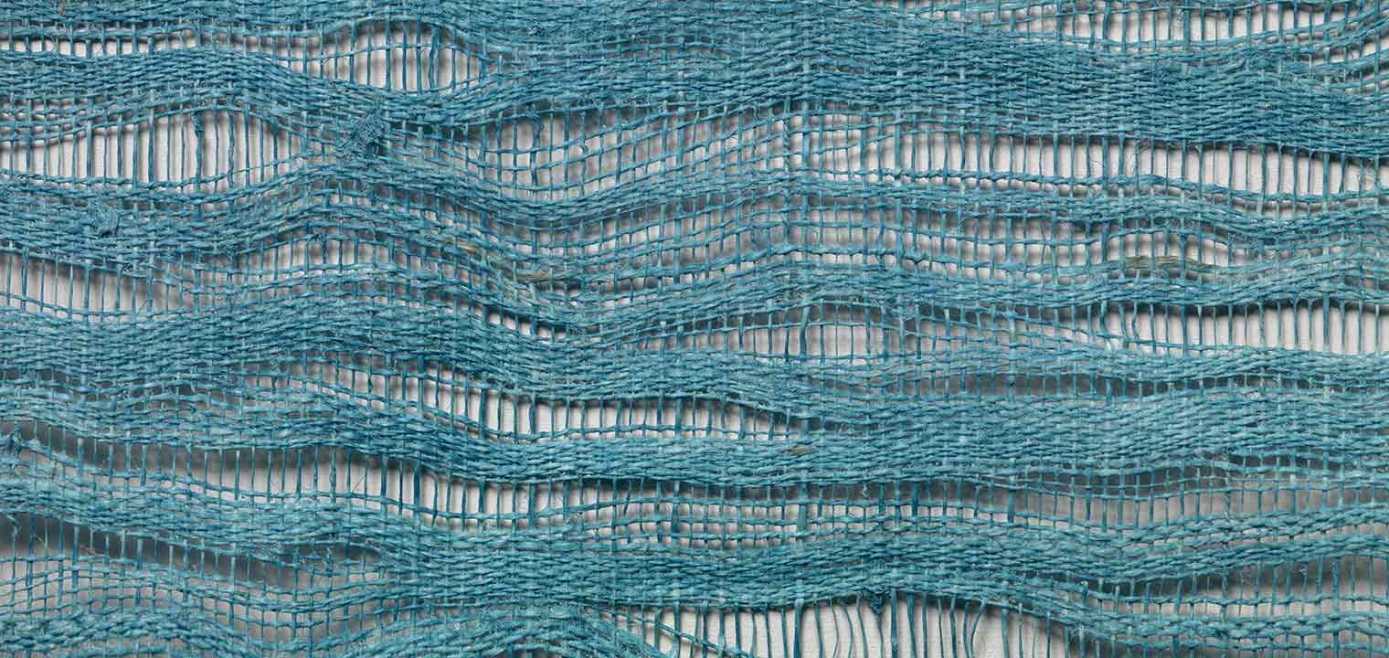 Detail from a blue, open weave textile