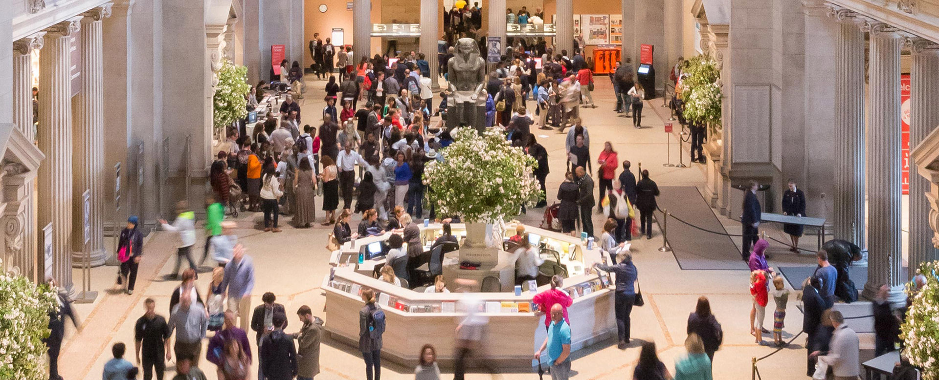View of The Metropolitan Museum of Art's great hall filled with visitors.