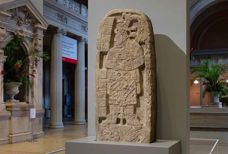 Maya stele of a portrait of a queen regent trampling a captive in The Met's Great Hall