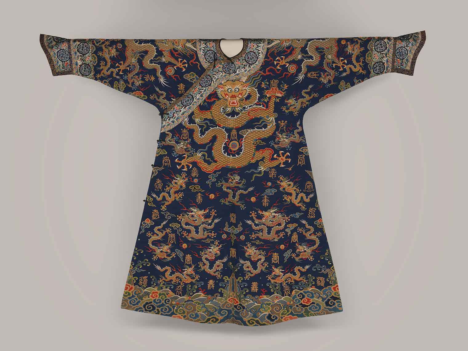 A robe with a large dragon design and other symbols throughout.