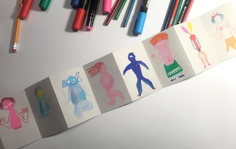 Drawn characters on the folded strip of paper with some details added. 