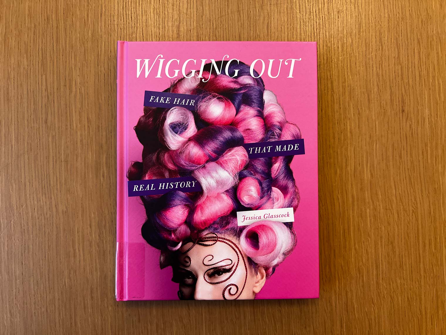 Pink cover featuring wig
