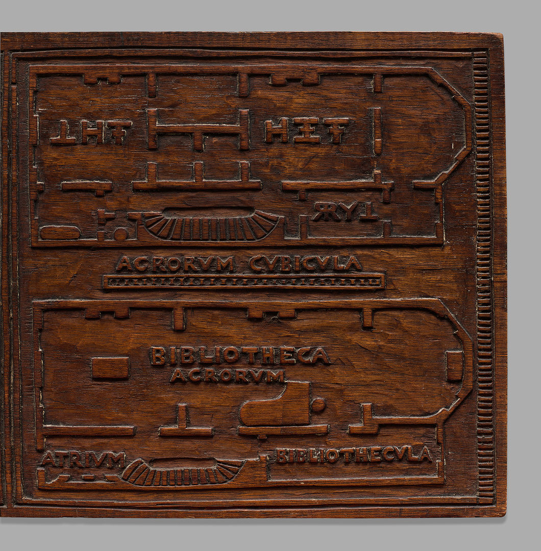 Image of an apartment floorplan engraved onto a wood relief panel. 