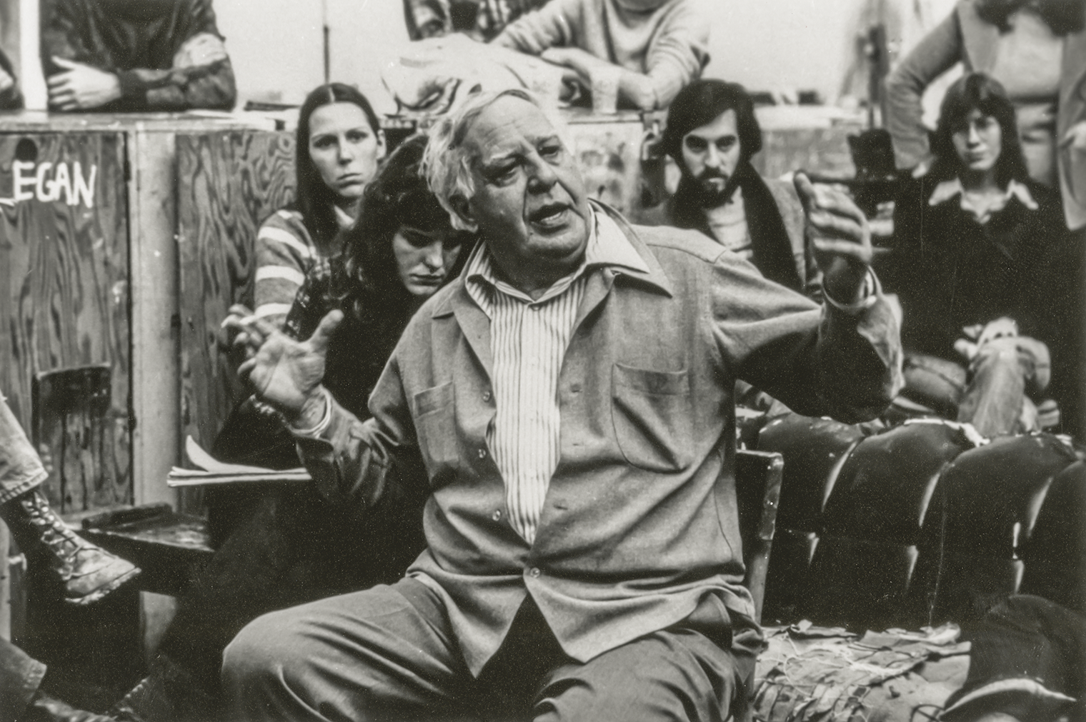 Shot of Guston lecturing with students around him. 