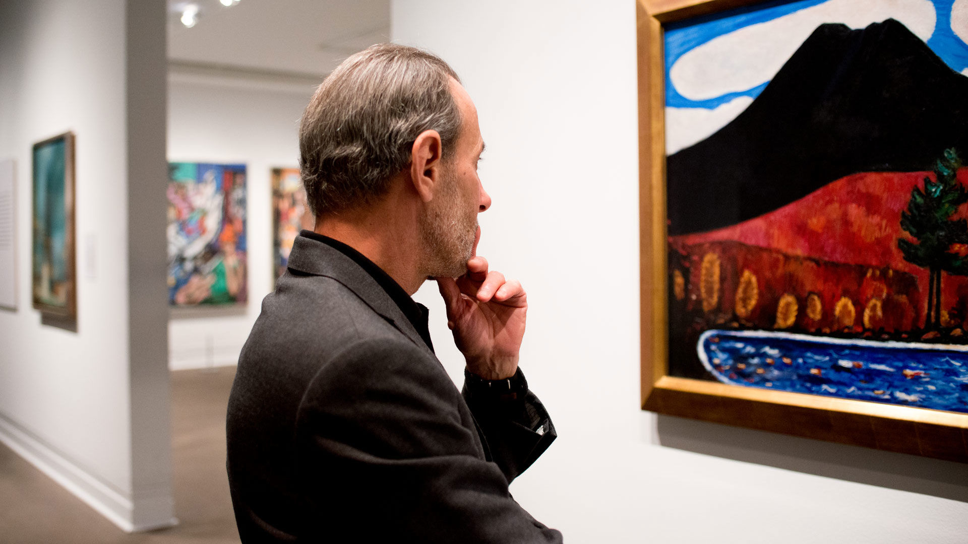 David Salle looking at a Marsden Hartley painting