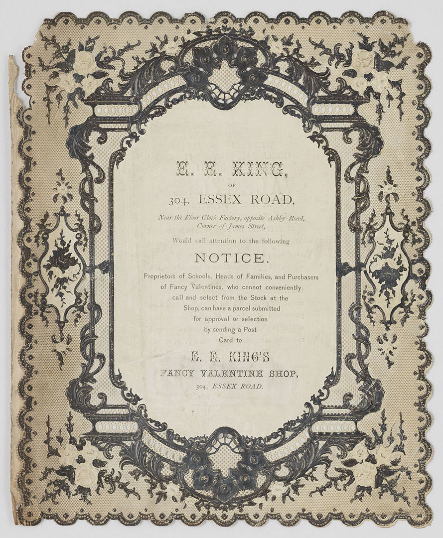 An advertisement for a Valentine shop on paper lace bordered with silver flowers.