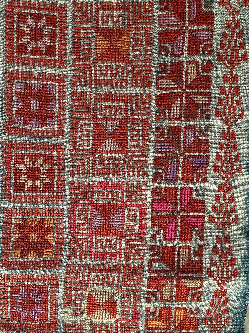 Fragment of a throbe with embroidery in vibrant colors, including red, pink, purple, and orange.