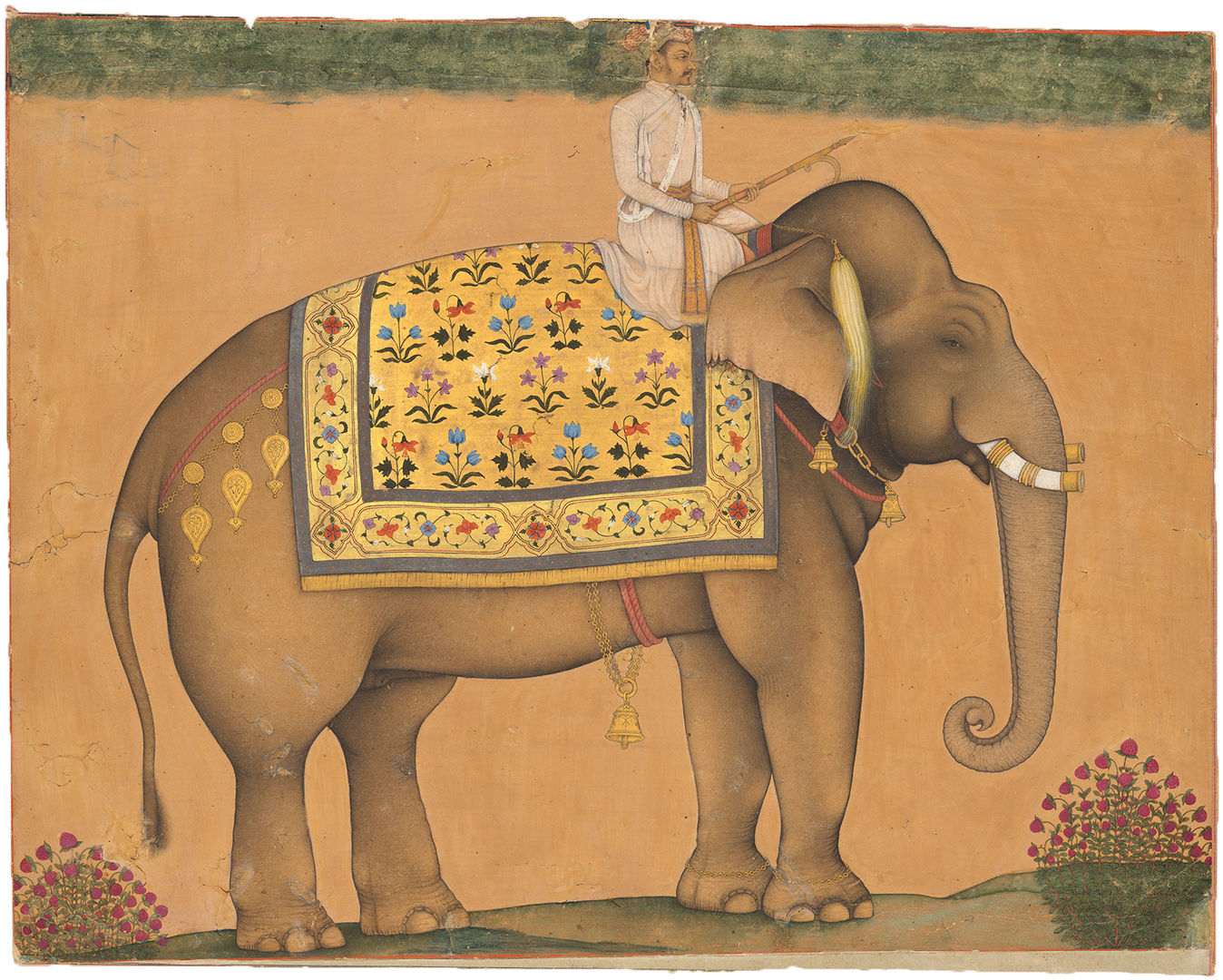 Traditional Indian painting of an elephant standing in profile with a yellow decorated clothe and a rider wearing white. Yellow background.