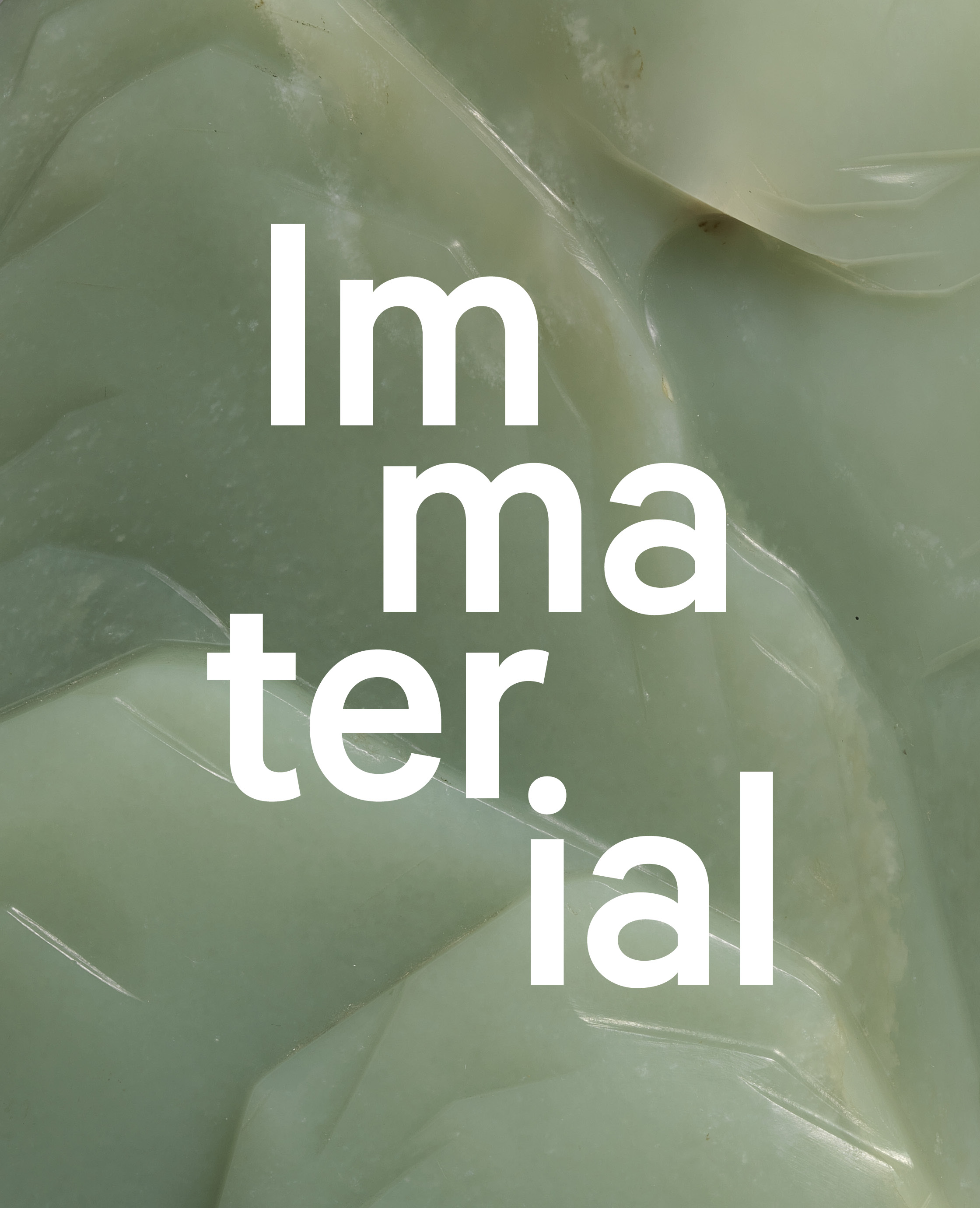 Extreme close-up of a carved piece of green jade with the text, 