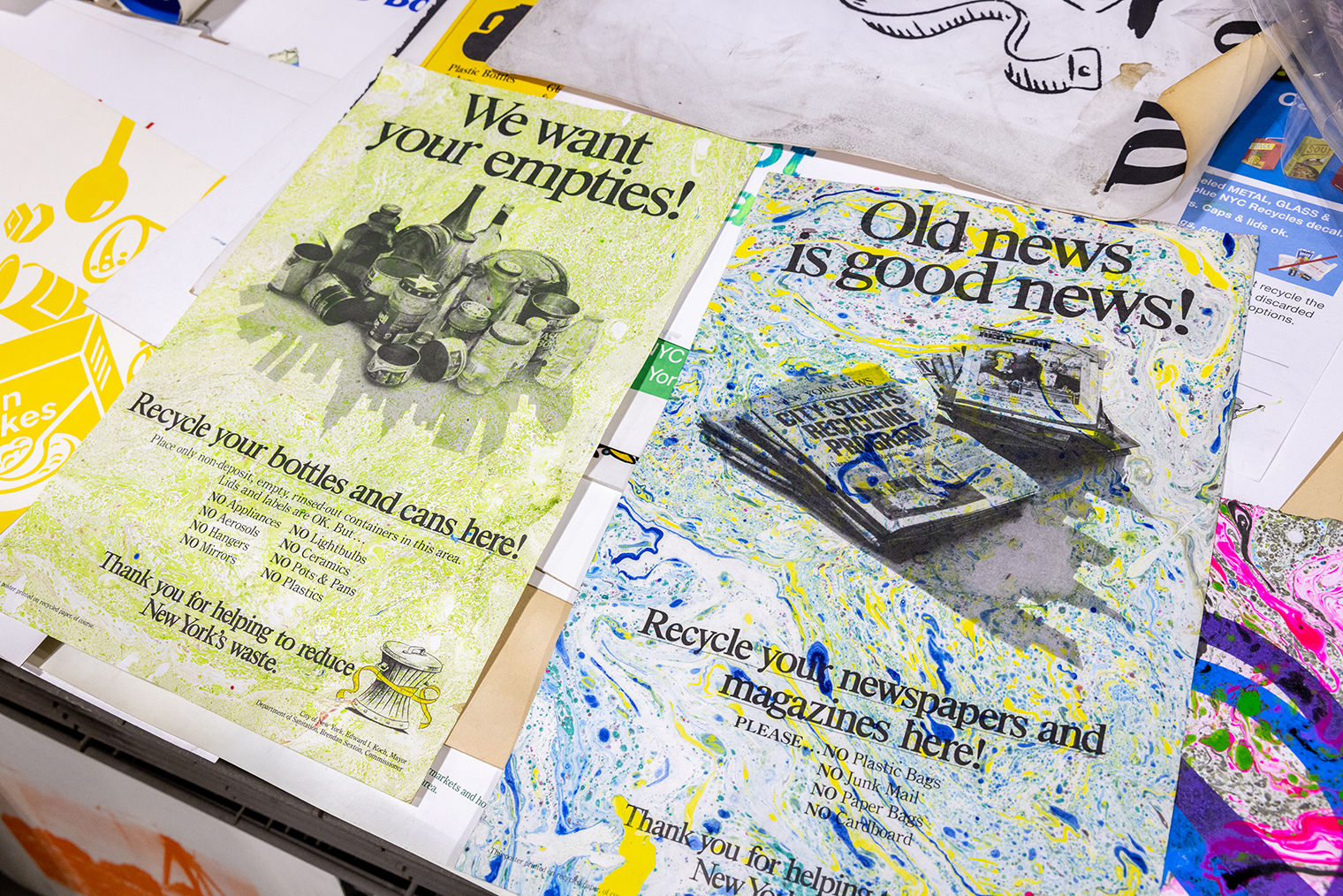 Colorful prints are superimposed over two old Sanitation Department posters.